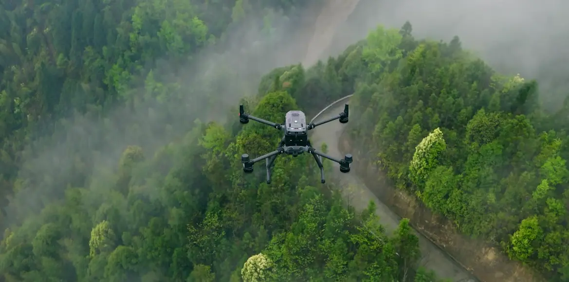 Product image of DJI Matric 350 RTK drone flying across forest